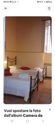 a bedroom with two beds with red pillows at Piazza Navona Apartment in Rome
