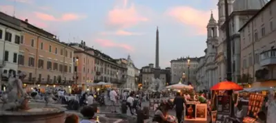 a crowd of people walking down a city street at Piazza Navona Apartment in Rome