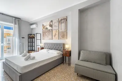 a bedroom with a bed and a chair at Vatican 2bedr apt in Rome