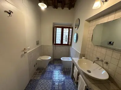 a bathroom with a sink and a toilet and a mirror at Greci Suite in Rome
