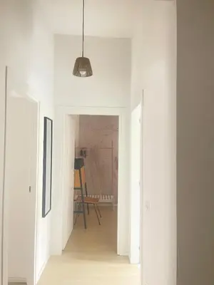 a hallway with white walls and a pendant light at Testaccio sul Tevere romantic historical close FAO in Rome