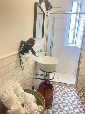 a bathroom with a sink and a shower with towels at Testaccio sul Tevere romantic historical close FAO in Rome