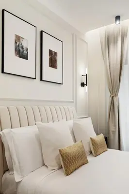 a white bedroom with a white bed with pillows at Piave Boutique Guest House in Rome
