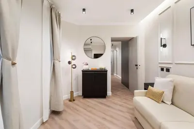 a living room with a white couch and a mirror at Piave Boutique Guest House in Rome