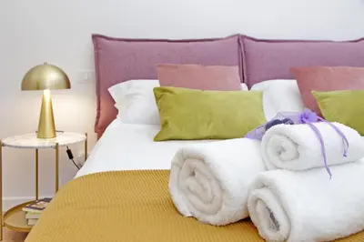 a bedroom with a bed with towels on it at Binario 30 in Rome