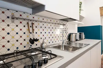 a kitchen with a stove and a sink at Domus Maggiore Apartment in Rome