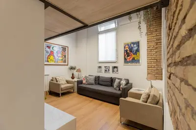 a living room with a couch and two chairs at iFlat Cozy & Serene Loft Two Steps from Vatican in Rome