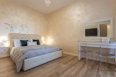 a bedroom with a bed and a desk and a television at San Pietro Panoramic View in Rome