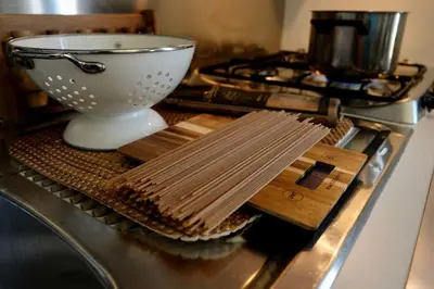 a kitchen counter with wooden utensils on a stove at Gioia House in Rome