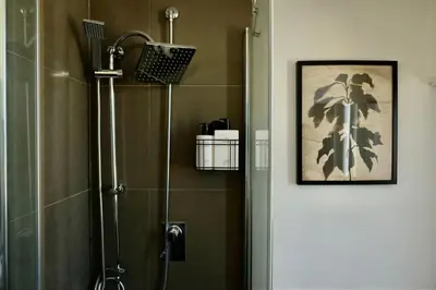 a bathroom with a shower with a glass door at Gioia House in Rome