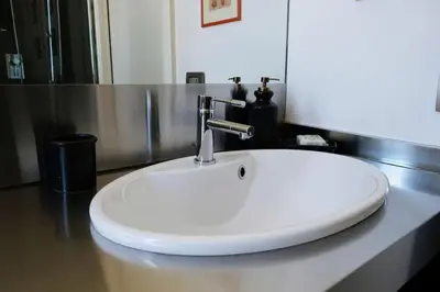 a white sink on a counter in a bathroom at Gioia House in Rome