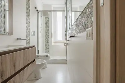 a bathroom with a toilet and a sink at Maison Riboty - by 101Flats in Rome