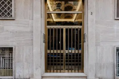 a large glass door in a stone building at Maison Riboty - by 101Flats in Rome