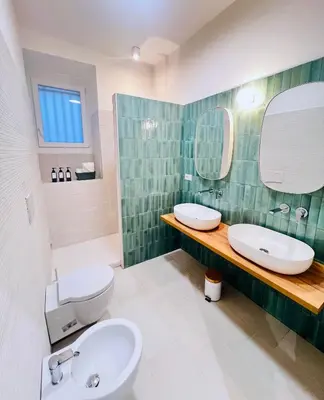 a bathroom with a sink and a toilet and a mirror at Flowflat Vatican in Rome