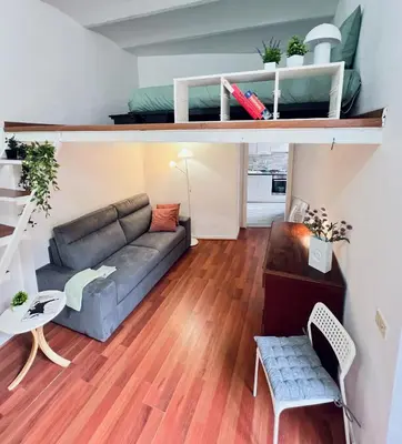 a living room with a couch and a table at FlowflatPigneto in Rome