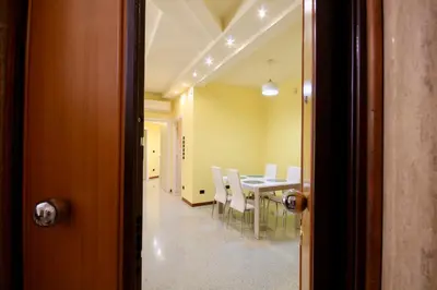 a dining room with a table and white chairs at HC - CloHouse Spacious Flat in Rome