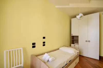 a bedroom with a bed and a yellow wall at HC - CloHouse Spacious Flat in Rome