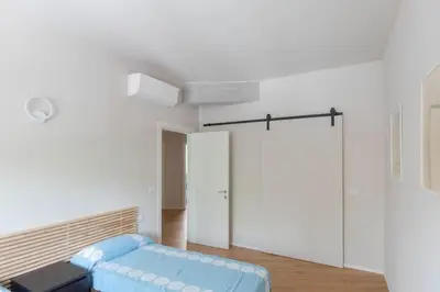 a white room with a door and a stool at Modern Spacious Apartment on the Tevere in Rome