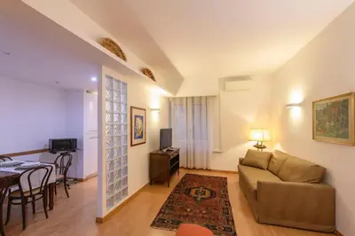 a living room with a couch and a table at St Peter s Home, nel cuore della Città Eterna in Rome