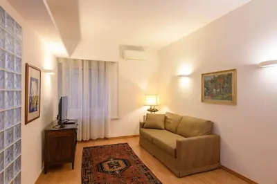 a living room with a couch and a television at St Peter s Home, nel cuore della Città Eterna in Rome