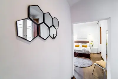 a bedroom with a mirror and a bed at Sant'Angelo Apartments in Rome
