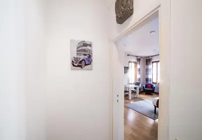 a hallway with a picture of a car on the wall at Sant'Angelo Apartments in Rome