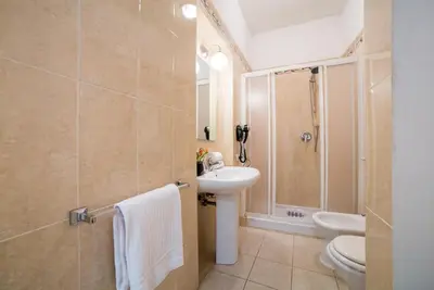 a bathroom with a sink and a toilet and a shower at Sant'Angelo Apartments in Rome