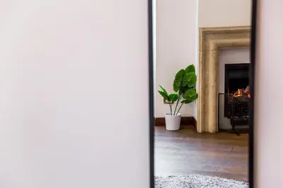 a living room with a fireplace and a mirror at Sant'Angelo Apartments in Rome