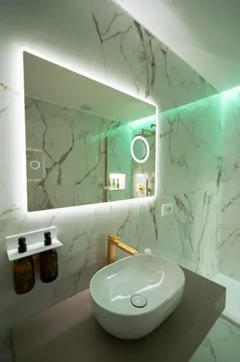 a bathroom with a white sink and a mirror at 56 Orange Street Luxury Accommodation in Rome
