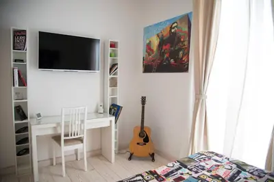 a bedroom with a bed with a painting on the wall at Big Johnny B in Rome
