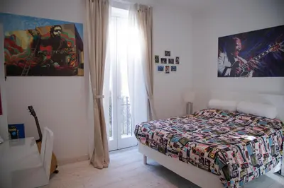 a bedroom with a bed and a desk and a television at Big Johnny B in Rome