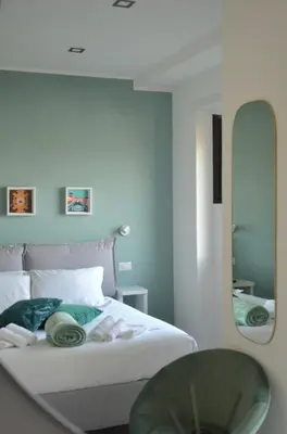 a bedroom with a bed with a mirror and a table at Vatican View Experience in Rome