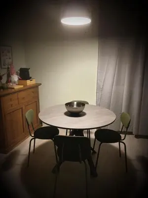 a table with four chairs and a bowl on top at Appartamento La Doriana in Rome