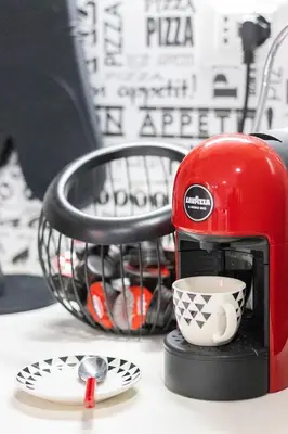 a red coffee maker sitting on a table with a cup at Casa Gabea in Rome
