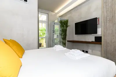 a small balcony with two tables and plants at New Modern in Trastevere with Garden in Rome