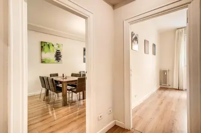 a dining room with a table and chairs and a room with a mirror at Suite Experience San Giovanni Apartments in Rome