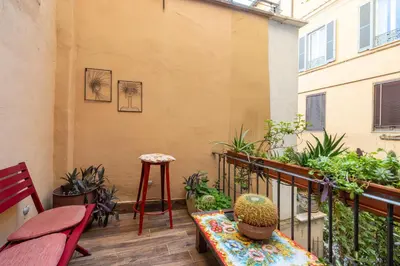 a balcony with a table and some plants on it at Cesare Balbo - B&D Apts in Rome