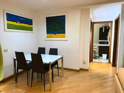 a dining room with a table and chairs in a room at 10 Min to Metro Cozy Apartment Near City Center in Rome