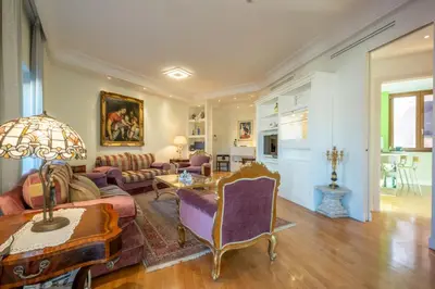 a living room with a couch and a table at Trevi Terrace Penthouse in Rome