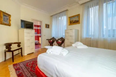 a bedroom with a large white bed in a room at Trevi Terrace Penthouse in Rome