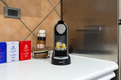 a black blender sitting on a counter next to books at Casa Coronari in Rome
