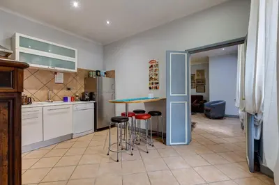 a kitchen with a table and stools in it at Casa Coronari in Rome