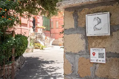 a sign on the side of a building with a sign at Lilli's Home Garbatella in Rome