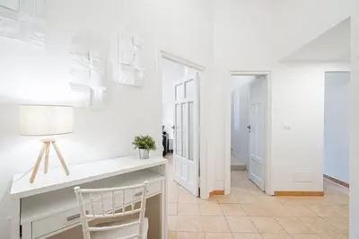 a white room with a desk and a chair at Lilli's Home Garbatella in Rome