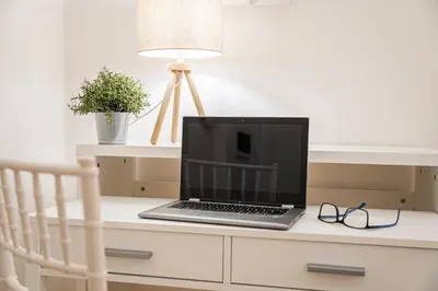 a laptop computer sitting on a desk with a chair at Lilli's Home Garbatella in Rome
