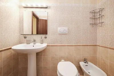 a bathroom with a sink and a toilet and a mirror at Colosseum 3 rooms & 4 bathrooms with garden in Rome