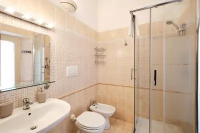 a bathroom with a toilet sink and a shower at Colosseum 3 rooms & 4 bathrooms with garden in Rome