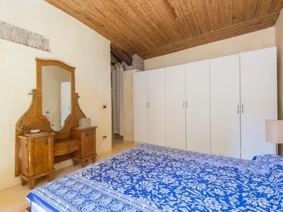a bedroom with a blue bed and a mirror at Charming Luxury Trastevere Apartment in Rome