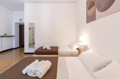 a room with two beds and towels on a rug at Typical & Cozy Apartment - Testaccio - Trastevere in Rome