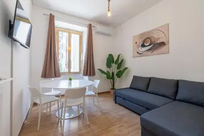 a living room with a couch and a table at Typical & Cozy Apartment - Testaccio - Trastevere in Rome